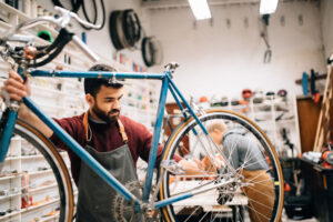 Bicycle shop owner repairing a bike