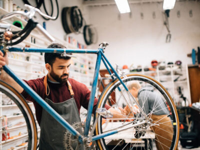 Bicycle shop owner repairing a bike