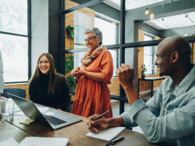 Group of business people engaged with each other in a modern office