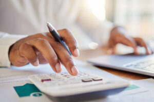 Closeup of hand and calculator