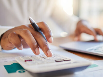 Closeup of a hand and a calculator