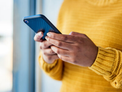 Person with a mobile device closeup