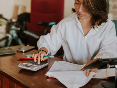 Woman adding up receipts for budget