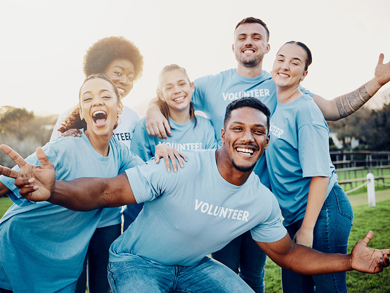 Volunteers in matching shirts posing as a group
