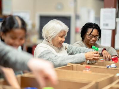 Volunteers packing boxes at a local food bank