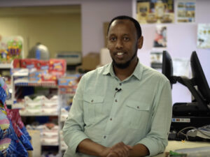 Photo of Faisal Yusuf, owner of Midway Convenience & Deli