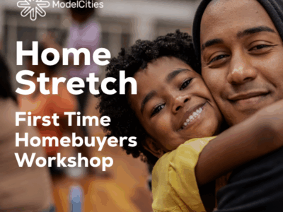 Parent with child, smiling and facing the camera